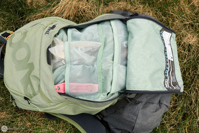 EVOC Trail Pro 16L backpack open revealing multiple storage compartments