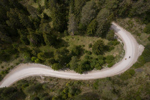 EVOC gravel bike riders overhead view on winding road
