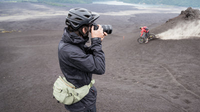EVOC Capture camera hip pack worn by photographer shooting pictures of mountain biker