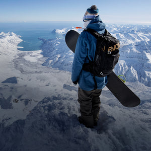 EVOC winter protection backpack worn by snowboarder atop a snowy mountain mobile view