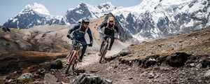 Mountain bikers riding with EVOC protector backpacks in Peru