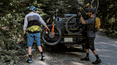 Male mountain bikers wearing EVOC hip pack and hydration backpack